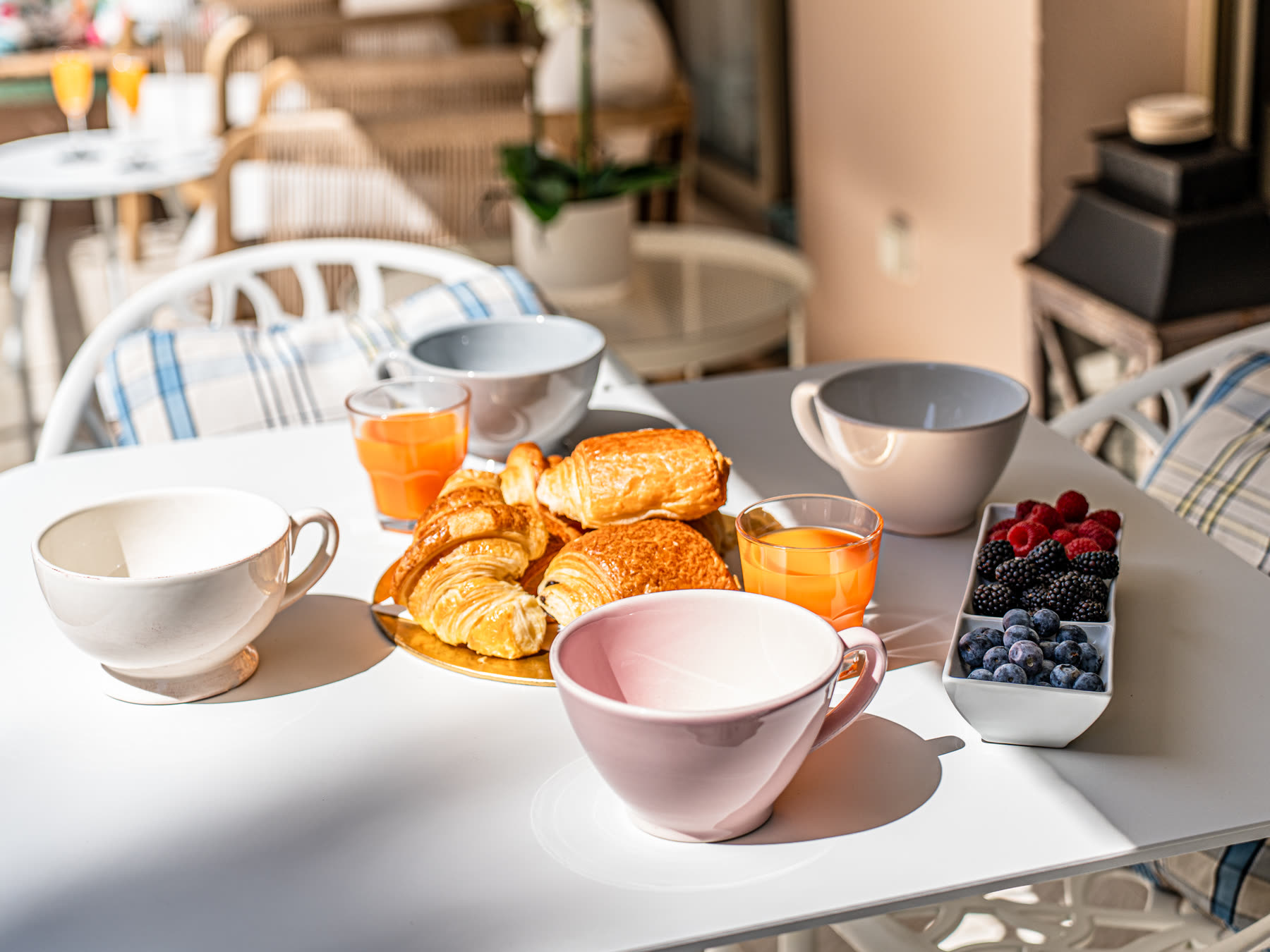 Breakfast of croissants and fresh berries on the terrace