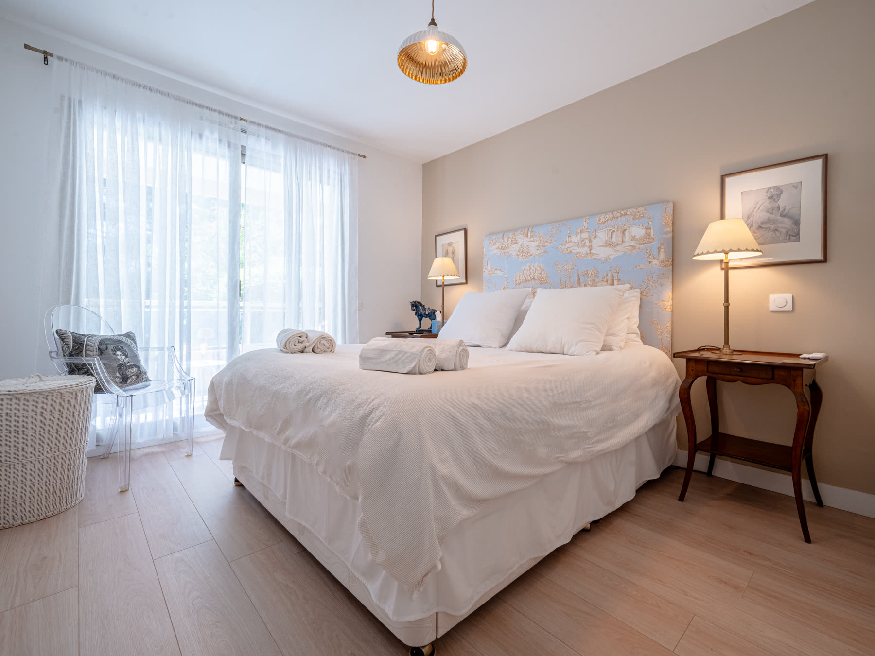 Main bedroom with blue toile headboard and white linen